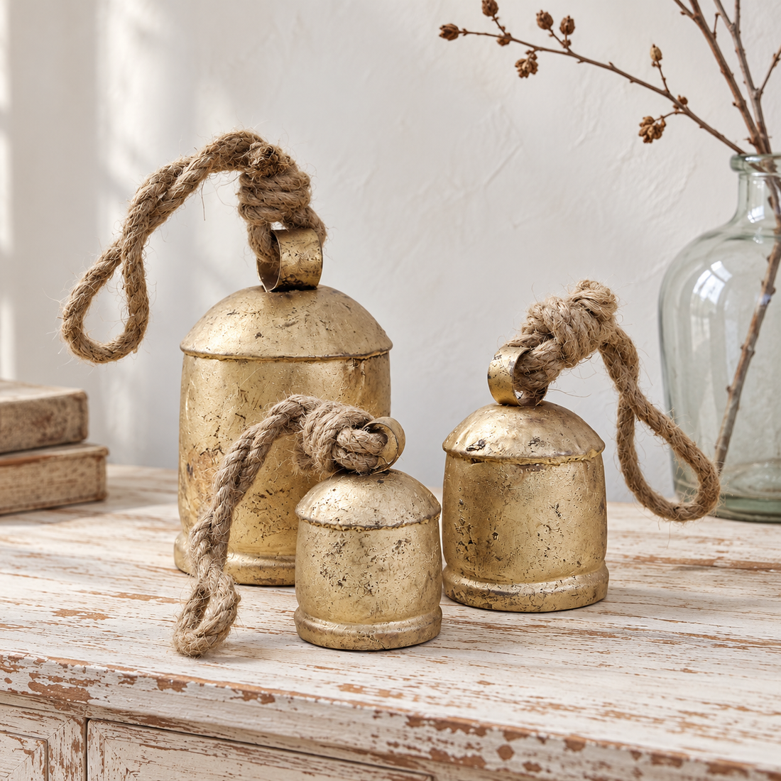 Rustic bell trio arranged on a sideboard